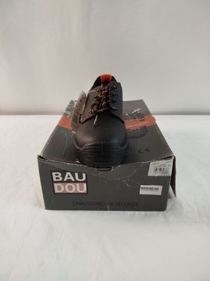 men ' s bau shoes in a box on a white surface