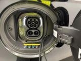 a close up of a car ' s charging station with a car plugged into it
