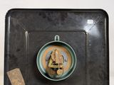 a black tray with a cup of coffee and a tag on it