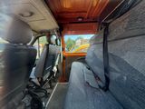 two seats in the back of a van with a bag on the back