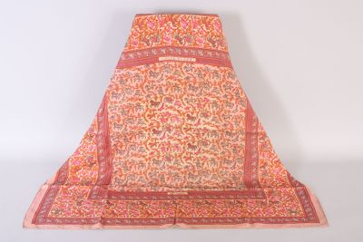 an orange and pink floraled shawl on a white background