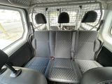 two seats in the back of a van with a dog in the back