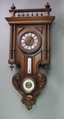 a wooden clock hanging on the wall in a room