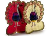 two decorative figurines of a peacock on display
