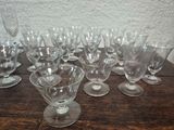 a lot of wine glasses sitting on a wooden table