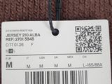 the label on a brown sweater is attached to a hanger