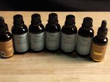 several bottles of essential oils sitting on a wooden table