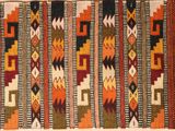 a close up of a colorful rug with a pattern on it