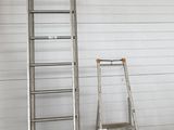 two ladders that are standing in front of a garage door