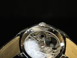 a close up of a watch on a black background