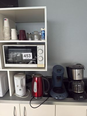 many different appliances on the counter in this kitchen
