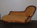 an image of a chaise lounger in the corner of a room
