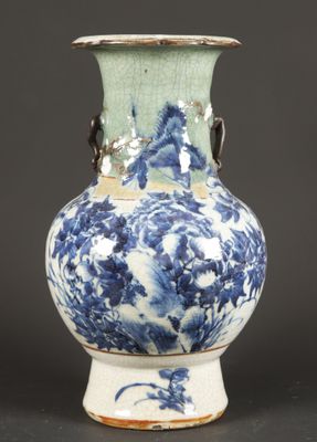 a blue and white vase sitting on a table