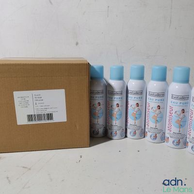 several bottles of lotion sitting next to a cardboard box on a table