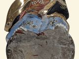 a statue of a woman sitting on top of a rock