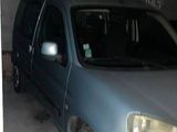a blue van that is parked in a garage