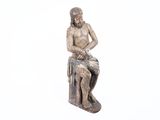 a statue of a man sitting on top of a box
