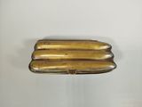 brass plate with four bananas on it sitting on a white surface