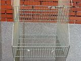 two cages that are next to each other on the sidewalk
