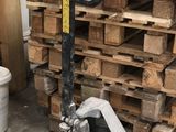 a pallet that is sitting in front of a stack of wood pallets