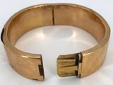 gold cuff bracelet with a square cut out of the middle