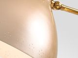 an image of a gold desk lamp on a white background
