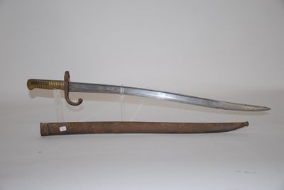 an old sword with a wooden handle on a white surface