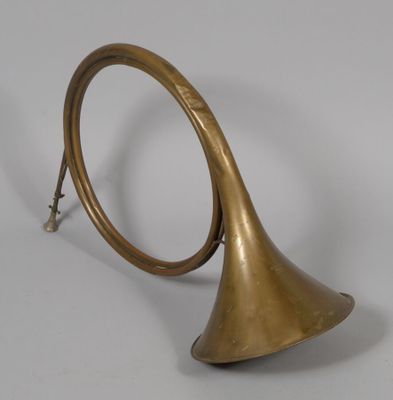 an old brass trumpet with a bell on a white background