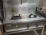 a stove and a stove top in a commercial kitchen