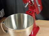 an image of a red mixer on a wooden table