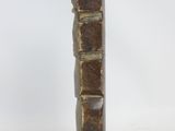 a brown vase that is sitting on a white surface