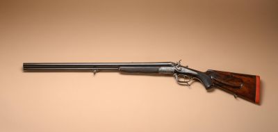 a rifle on a wall with a brown background