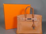an orange box and a brown bag sitting next to each other