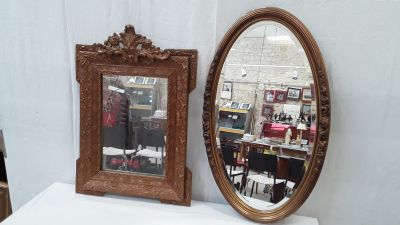 two mirrors sitting on a white table next to each other