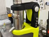 yellow and black blender sitting on top of a counter in a kitchen