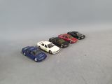 several toy cars are lined up in a row on a white surface