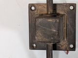 an old iron wall mounted light with a switch on it