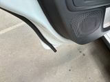 a close up of a car door with a speaker in it