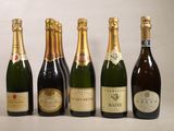 six bottles of champagne are lined up on a white surface