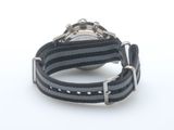 a watch that is sitting on top of a black and grey strap