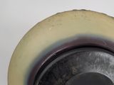 a close up of a metal object with a white background