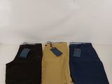 three pairs of men ' s pants sitting on a white surface