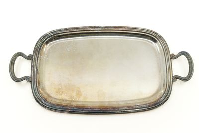 an antique silver plate with handles and handles on a white background