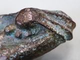 a statue of a frog that is sitting on top of a rock