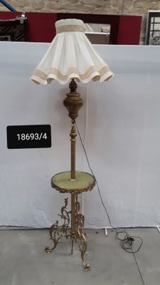 a lamp that is sitting on a table next to a wall