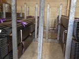 a room full of steel pipes and racks in a warehouse