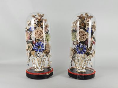 pair of decorative glass vases with flowers in them on a table