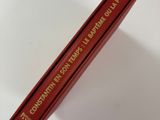 a red book that is laying on a white surface