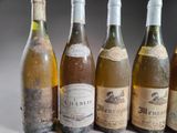 several bottles of wine are lined up on a table