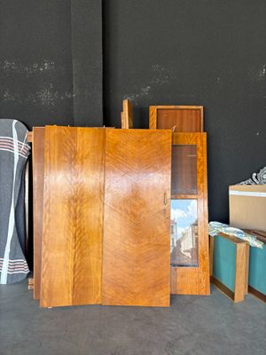 Plusieurs morceaux de bois sont empilés les uns sur les autres devant un mur noir